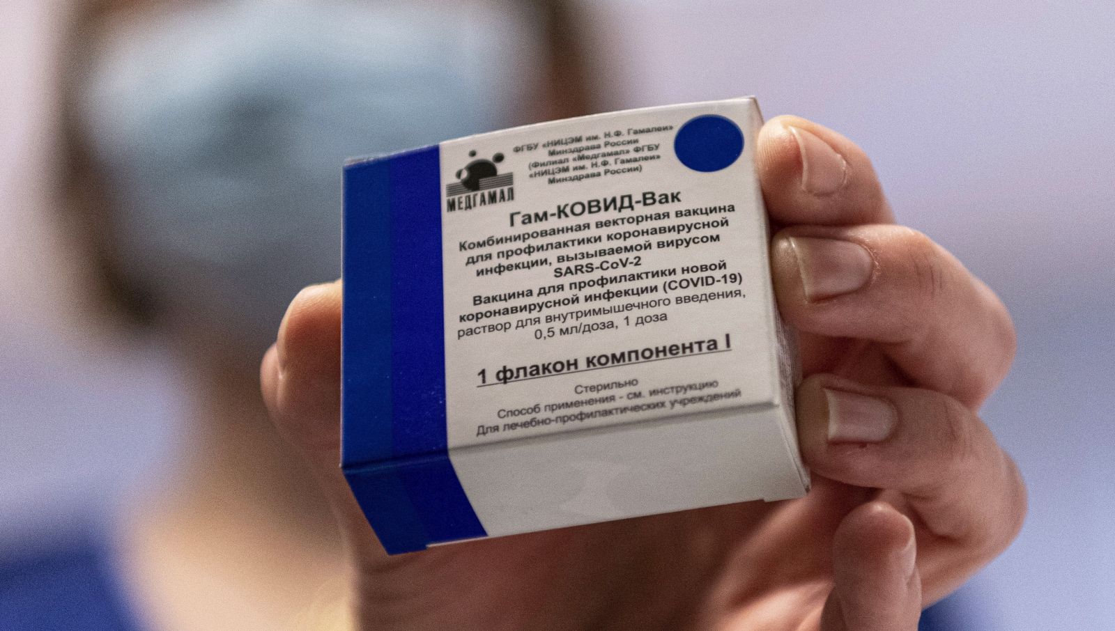 epa09006873 A box containing Russian vaccine Sputnik V is shown by a nurse at Central Hospital of the Hungarian Defence Forces (military) in Budapest, Hungary, 12 February 2021 as the vaccination with Sputnik V agains covid-19 begins in the country.  EPA/ZSOLT SZIGETVARY HUNGARY OUT