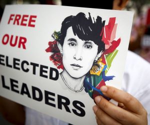 epa09018531 A Myanmar demonstrator wearing a protective face mask holds a sign with the image of Myanmar democracy icon Aung San Suu Kyi during a protest against the Myanmar military coup, outside the United Nations building in Bangkok, Thailand, 17 February 2021. Myanmar nationals living in Thailand continue to rally against the military coup, and in support of their democratic leader Aung San Suu Kyi and other top political leaders who were detained in a raid during a military coup, after tensions rose between the civilian government and the military, who disputed the legitimacy of the November 2020 elections results.  EPA/DIEGO AZUBEL
