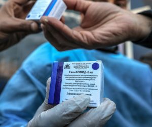 epa09028509 Palestinian Health employees receive the Covid-19 vaccines after a shipment crossed through Rafah crossing border from the United Arab Emirates, in Rafah crossing border between Egypt and Gaza strip, 21 February 2021. The second shipment of 20,000 Sputnik V coronavirus vaccines is sent by the United Arab Emirates.  EPA/MOHAMMED SABER