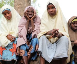 epa09039160 Students, who escaped from gunmen, wait outside the school premises for their parents after gunmen abducted more than 300 students at the Jangebe Government Girls Secondary School, Zamfara State, Nigeria 26 February 2021. According to regional police over 300 girl students were abducted by gunmen in Jangede marking this as the third school attack in Nigeria in less than three months.  EPA/STR