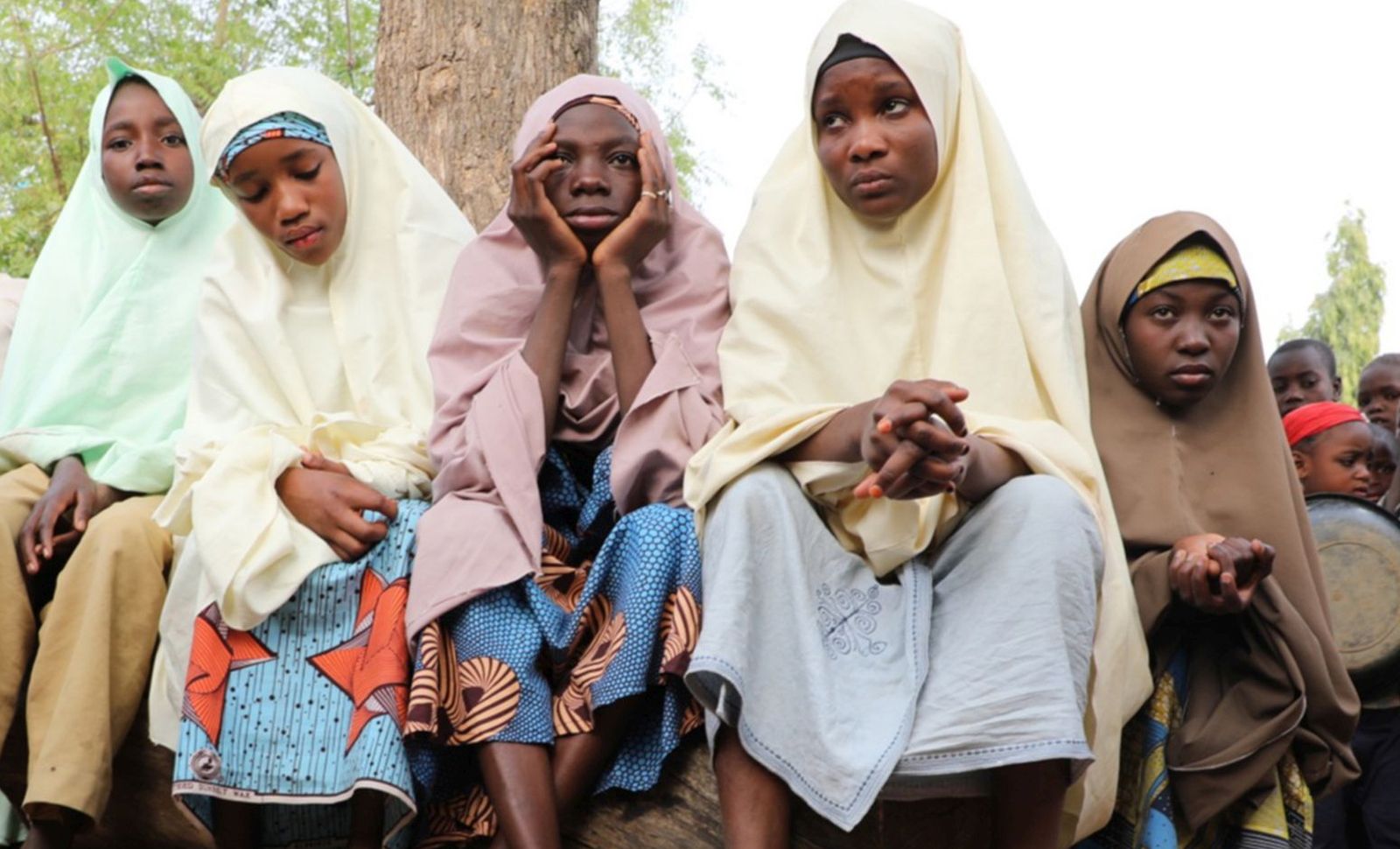 epa09039160 Students, who escaped from gunmen, wait outside the school premises for their parents after gunmen abducted more than 300 students at the Jangebe Government Girls Secondary School, Zamfara State, Nigeria 26 February 2021. According to regional police over 300 girl students were abducted by gunmen in Jangede marking this as the third school attack in Nigeria in less than three months.  EPA/STR