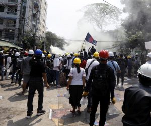 epa09047910 Protesters flee from tear gas launched by police during a protest against the military coup in Yangon, Myanmar, 03 March 2021. Foreign ministers of the Association of Southeast Asian Nations (ASEAN) call for a halt of violence during a meeting on 02 March as protests continued amid rising tension in the country between anti-coup protesters and security forces.  EPA/NYEIN CHAN NAING
