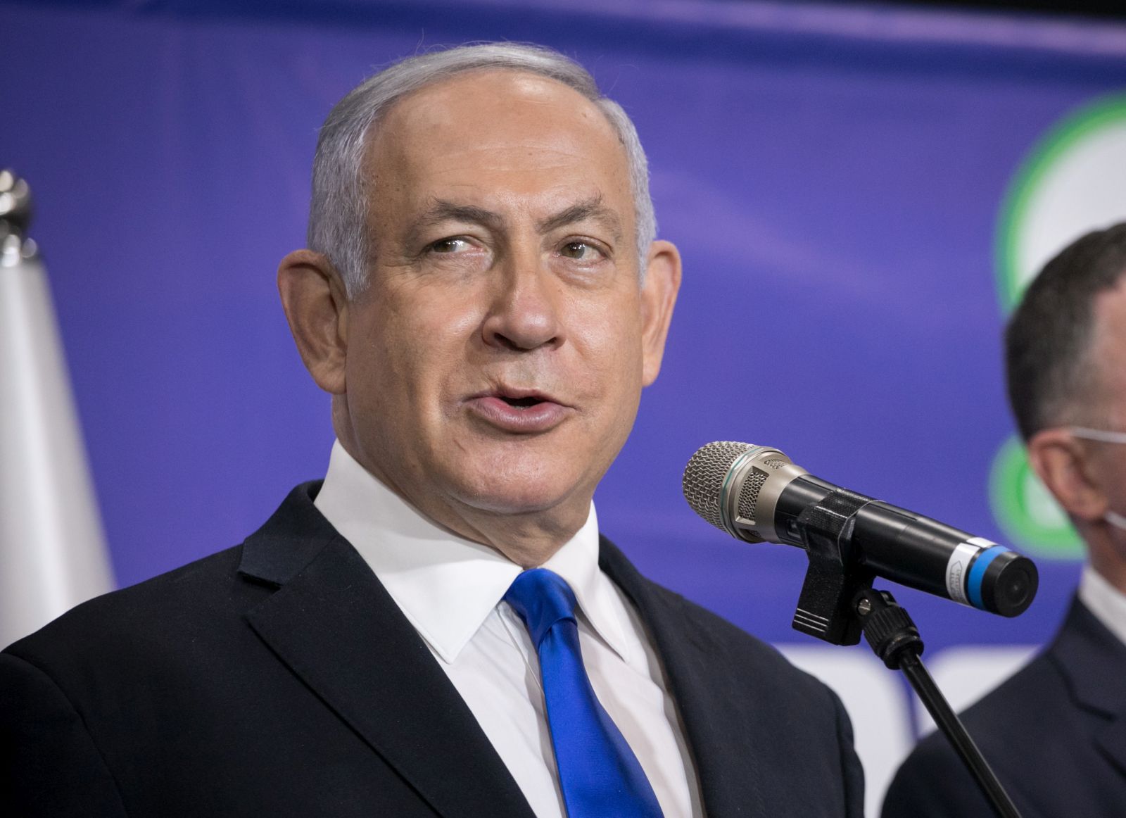 epa09061474 Israeli Prime Minister Benjamin Netanyahu speaks to the media after his meeting with  the Israeli citizen no. 5,000,000  that get the Pfizer-BioNTech COVID-19 vaccine against the Covid-19 in Tel Aviv, Israel, 08 March 2021.  EPA/MIRIAM ALSTER / POOL