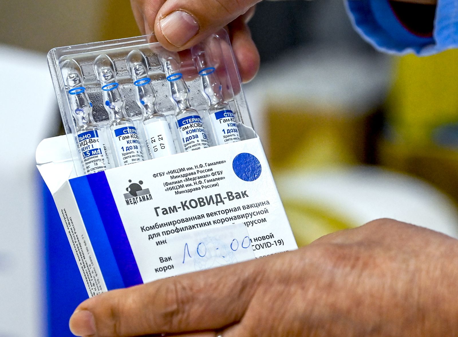 epa09065201 A nurse takes out from the box vials of the Russian Sputnik V vaccine against coronavirus - disease  (COVID-19) during vaccination at Jane Sandanski Polyclinic in Skopje, Republic of North Macedonia, 10 March 2021. North Macedonia continues its coronavirus disease (COVID-19) vaccination campaign of medical workers with Russian Sputnik V vaccine.  EPA/GEORGI LICOVSKI