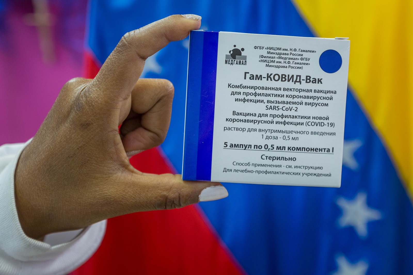 epa09069946 (FILE) A health worker of the Domingo Luciani hospital shows the Russian Sputnik V vaccine during a vaccination day against Covid-19 in Caracas, Venezuela, 04 March 2021 (issued 12 March). A year after the first cases of Covid-19 were detected in Venezuela, the number of infections continues to be one of the lowest in Latin America, with 144,277 people affected by the disease, which caused 1,415 deaths, according to official data. The figure is questioned by doctors and opponents who denounce an application of convenience tests in the midst of the weakened health system and given the lax quarantine like on celebration dates such as Christmas.  EPA/Miguel Gutierrez