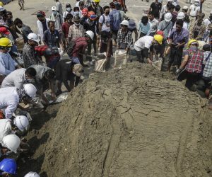 epa09071058 People make sandbags as they prepare to build a defensive line at a protest site in the Hlaingthaya (Hlaing Tharyar) Township, on the outskirts of Yangon, Myanmar, 13 March 2021. Anti-coup protests continued despite the intensifying violent crackdowns on demonstrators by security forces.  EPA/STRINGER