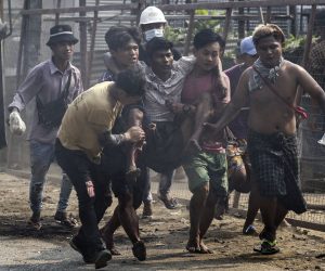 epa09073302 Protesters carry an injured demonstrator during a protest against the military coup in Hlaingthaya (Hlaing Tharyar) Township, outskirts of Yangon, Myanmar, 14 March 2021. Anti-coup protests continued despite the intensifying violent crackdowns on demonstrators by security forces.  EPA/STRINGER