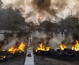 epa09073561 Protesters and resident (behind) make new road block after police burn their makeshift blockade near BayintNaung bridge which link to Hlaingthaya (Hlaing Tharyar) Township, outskirts of Yangon, Myanmar, 14 March 2021. Anti-coup protests continued despite the intensifying violent crackdowns on demonstrators by security forces.  EPA/STRINGER