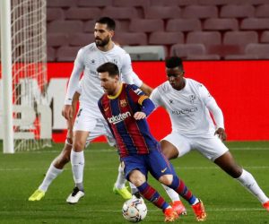 epa09077087 FC Barcelona's striker Leo Messi (C) vies for the ball with Huesca's midfielder Idrissa Doumbia (R)  during the Spanish LaLiga soccer match between FC Barcelona and SD Huesca held in Barcelona, Catalonia, Spain, 15 March 2021.  EPA/Toni Albir