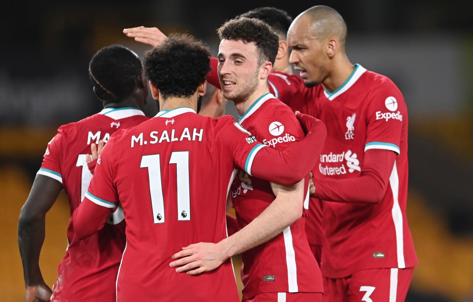 epa09077110 Diogo Jota (2-R) of Liverpool celebrates after scoring 1-0 leading with team mates during the English Premier League soccer match between Wolverhampton Wanderers and Liverpool FC in Wolverhampton, Britain, 15 March 2021.  EPA/Laurence Griffiths / POOL EDITORIAL USE ONLY. No use with unauthorized audio, video, data, fixture lists, club/league logos or 'live' services. Online in-match use limited to 120 images, no video emulation. No use in betting, games or single club/league/player publications.
