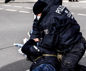epa09085258 Police detain a right-wing protester during a rally in Berlin, Germany, 20 March 2021. Some 1,800 police forces were deployed to face a rally by far-right wing and so-called 'Reich Citizens' demonstrators. The rally titled 'Peace, Freedom, Sovereignty' showed a lower turnout than expected.  EPA/FILIP SINGER