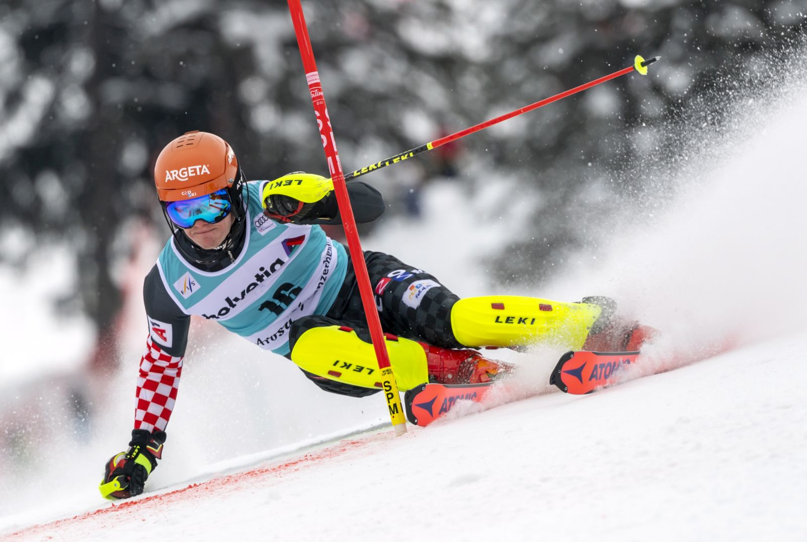 epa09087455 Croatia's Filip Zubcic clears a gate during the first run of the Men's Slalom race at the FIS Alpine Skiing World Cup finals in Lenzerheide, Switzerland, 21 March 2021.  EPA/JEAN-CHRISTOPHE BOTT