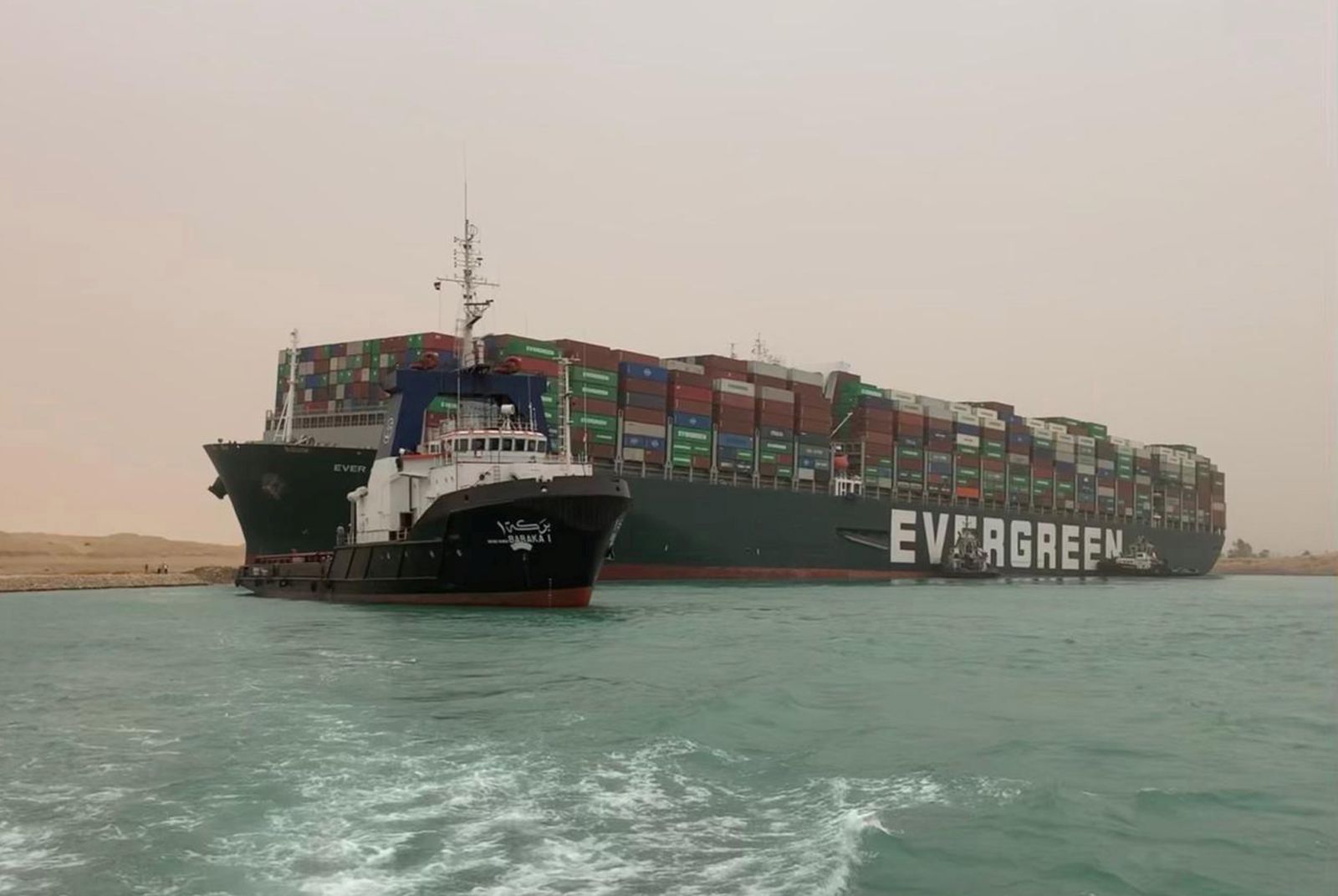 epa09092803 A handout photo made available by Media for the Suez Canal Head Office shows Egypt's Suez Canal blocked by a large container ship in Cairo, Egypt, 24 March 2021. A large container ship registered in Panama ran aground in the Suez Canal on 23 March, blocking passage of other ships and causing a traffic jam for cargo vessels.  EPA/Media Suez Canal Head Office / H  HANDOUT EDITORIAL USE ONLY/NO SALES