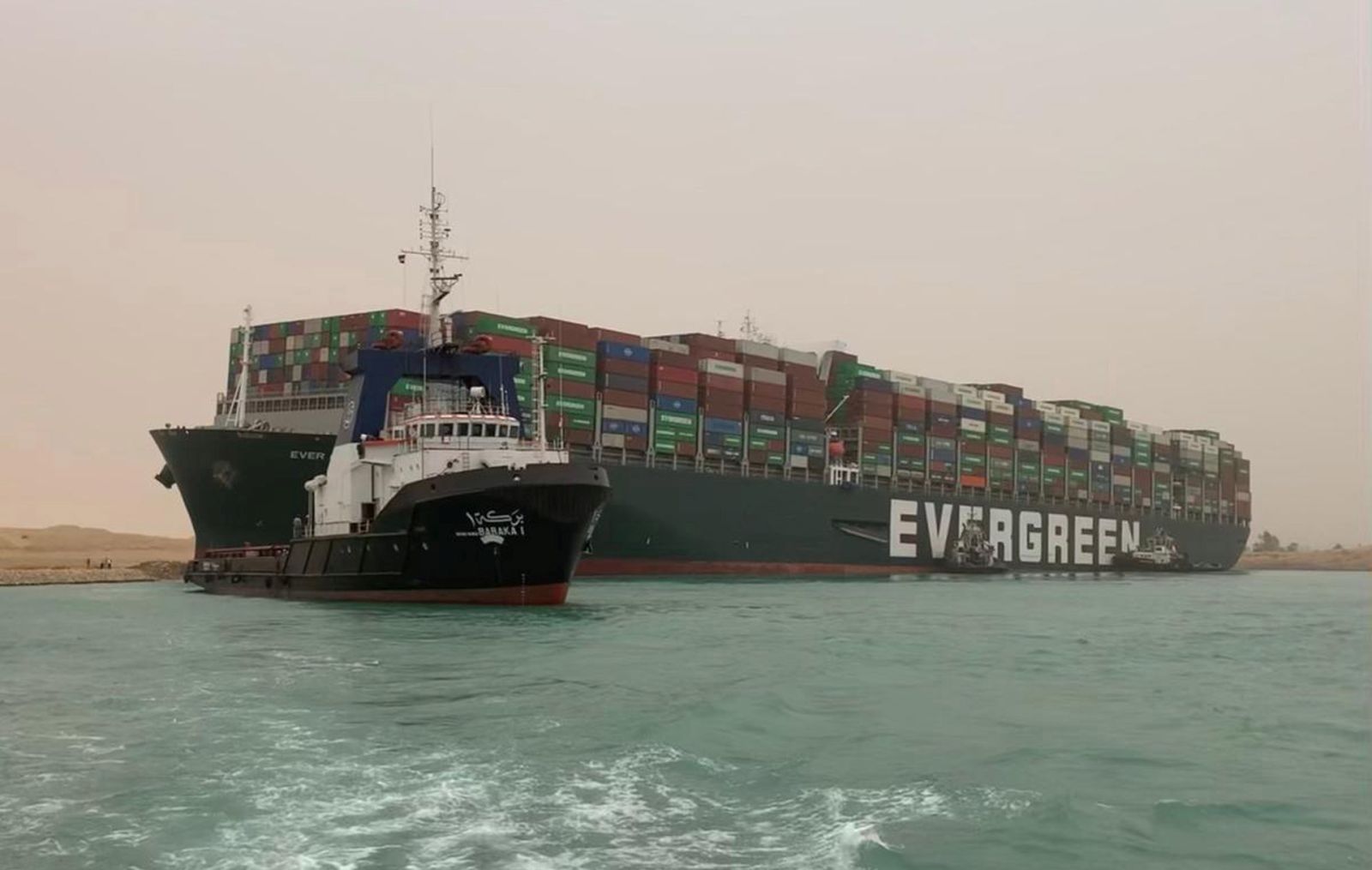 epa09092803 A handout photo made available by Media for the Suez Canal Head Office shows Egypt's Suez Canal blocked by a large container ship in Cairo, Egypt, 24 March 2021. A large container ship registered in Panama ran aground in the Suez Canal on 23 March, blocking passage of other ships and causing a traffic jam for cargo vessels.  EPA/Media Suez Canal Head Office / H  HANDOUT EDITORIAL USE ONLY/NO SALES