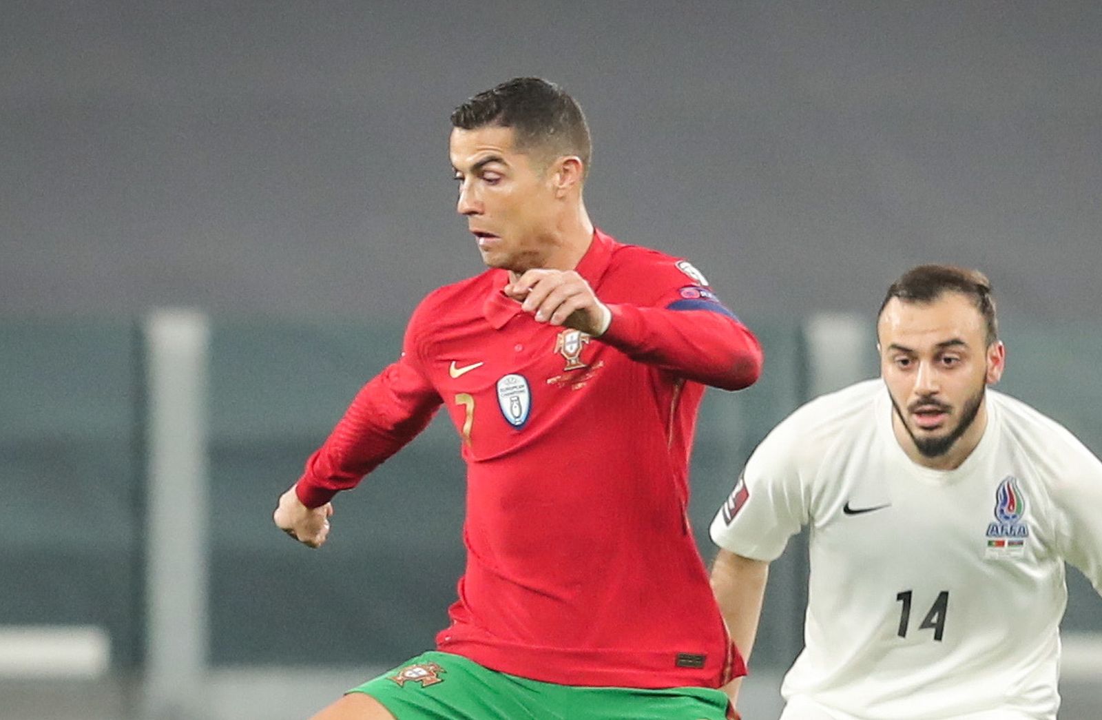 epa09094722 Portugal's Cristiano Ronaldo (L) fights for the ball with Azerbaijan's Elvin Badalov during the FIFA World Cup Qatar 2022 Group A qualifier match Portugal against Azerbaijan in Turin, Italy, 24 March 2021.  EPA/MIGUEL A. LOPES