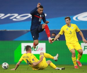 epa09094829 Kylian Mbappe (up) of France and Serhiy Kryvtsov (L) of Ukraine in action during the 2022 FIFA World Cup qualification UEFA Group D soccer match France vs Ukraine in Saint Denis, outside Paris, France, 24 March 2021.  EPA/CHRISTOPHE PETIT TESSON