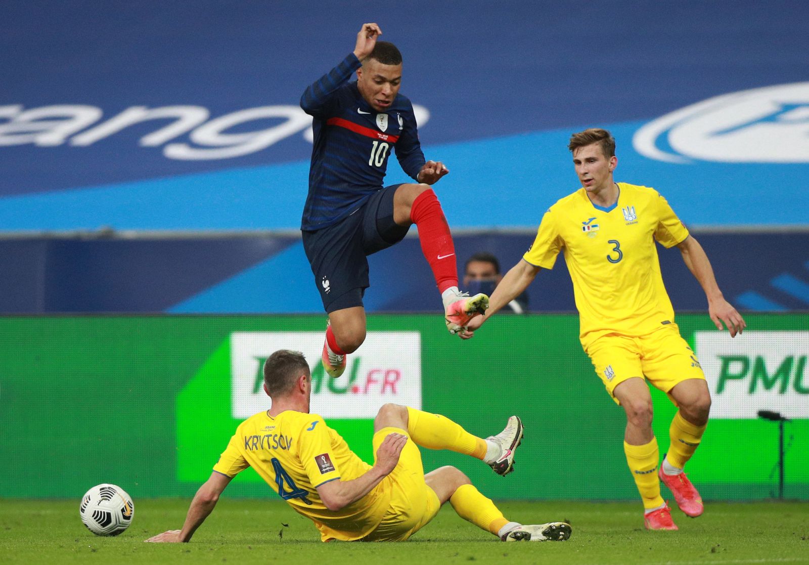 epa09094829 Kylian Mbappe (up) of France and Serhiy Kryvtsov (L) of Ukraine in action during the 2022 FIFA World Cup qualification UEFA Group D soccer match France vs Ukraine in Saint Denis, outside Paris, France, 24 March 2021.  EPA/CHRISTOPHE PETIT TESSON