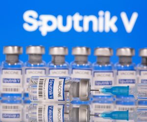 Vials labelled "Sputnik V Coronavirus COVID-19 Vaccine" and a syringe are seen in front of a displayed Sputnik V logo, in this illustration photo Vials labelled "Sputnik V Coronavirus COVID-19 Vaccine" and a syringe are seen in front of a displayed Sputnik V logo, in this illustration photo taken March 12, 2021. REUTERS/Dado Ruvic/Illustration DADO RUVIC
