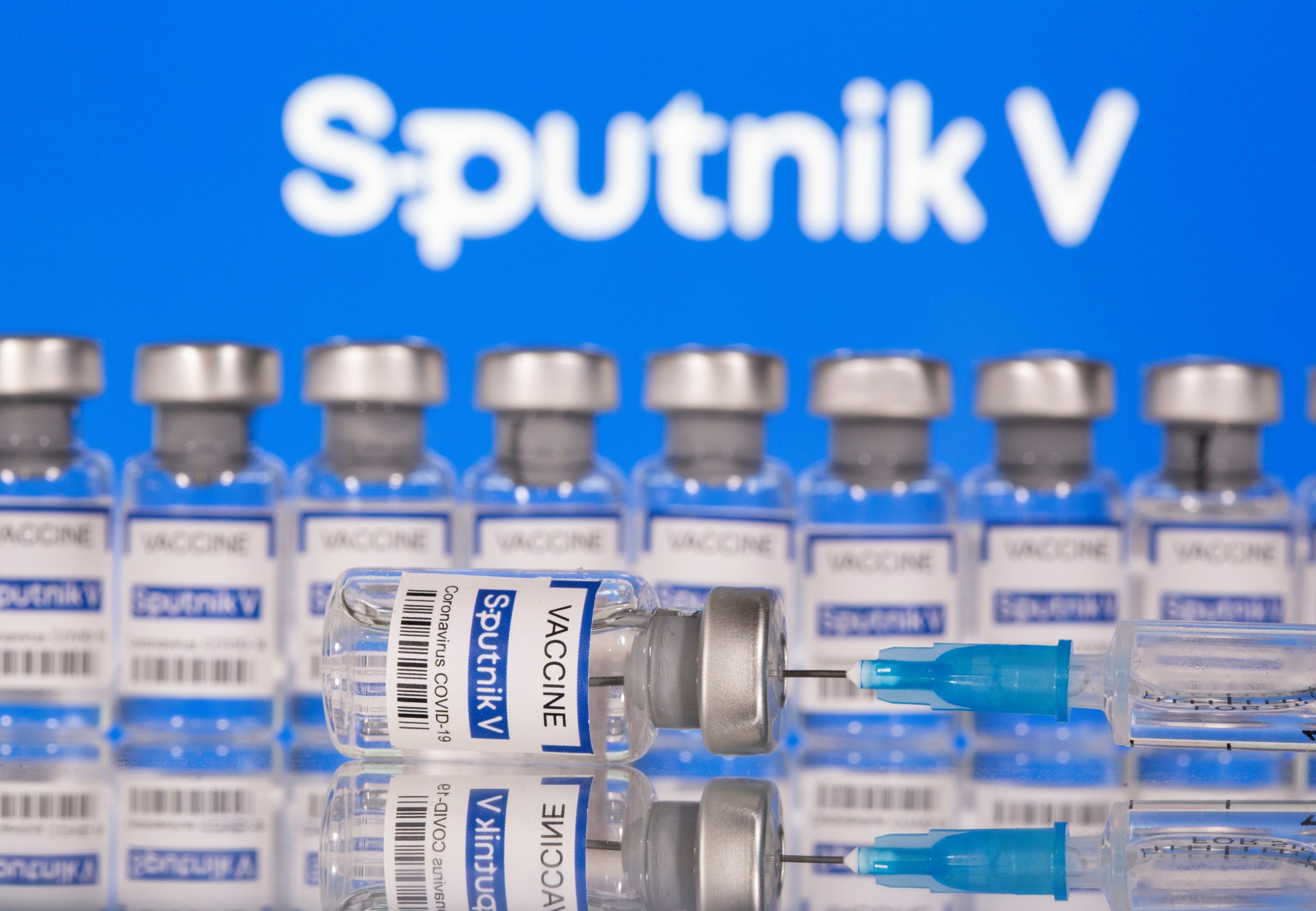 Vials labelled "Sputnik V Coronavirus COVID-19 Vaccine" and a syringe are seen in front of a displayed Sputnik V logo, in this illustration photo Vials labelled "Sputnik V Coronavirus COVID-19 Vaccine" and a syringe are seen in front of a displayed Sputnik V logo, in this illustration photo taken March 12, 2021. REUTERS/Dado Ruvic/Illustration DADO RUVIC
