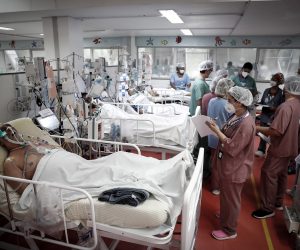 epa09072135 Medical personnel work at the ICU of the M'Boi Mirim Hospital, outskirts of Sao Paulo, Brazil, 12 March 2021 (issued 13 March 2021). The ICU of the M'Boi Mirim Hospital is crowded with patients with Covid-19.  EPA/FERNANDO BIZERRA