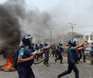 epa09102589 Bangladeshi police members fire rubber bullets and tear gas to disperse protesters as members of the Bangladeshi Islamic group Hefazat-e Islam block a road on Dhaka - Chittagong highway during the dawn to dusk countrywide strike, Dhaka, Bangladesh, 28 March 2021. Members of the Bangladeshi Islamic group Hefazat-e Islam called for the strike a day after at least five people were killed and dozens injured when police forces fired to disperse protest against Indian Prime Minister Narendra Modi's visit in Bangladesh.  EPA/MONIRUL ALAM