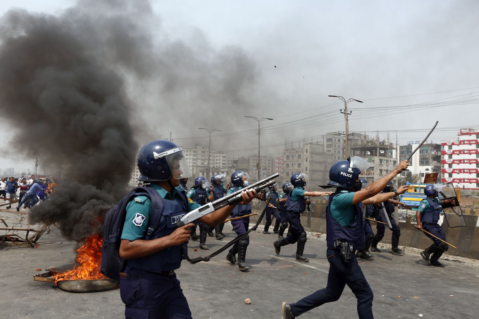 epa09102589 Bangladeshi police members fire rubber bullets and tear gas to disperse protesters as members of the Bangladeshi Islamic group Hefazat-e Islam block a road on Dhaka - Chittagong highway during the dawn to dusk countrywide strike, Dhaka, Bangladesh, 28 March 2021. Members of the Bangladeshi Islamic group Hefazat-e Islam called for the strike a day after at least five people were killed and dozens injured when police forces fired to disperse protest against Indian Prime Minister Narendra Modi's visit in Bangladesh.  EPA/MONIRUL ALAM