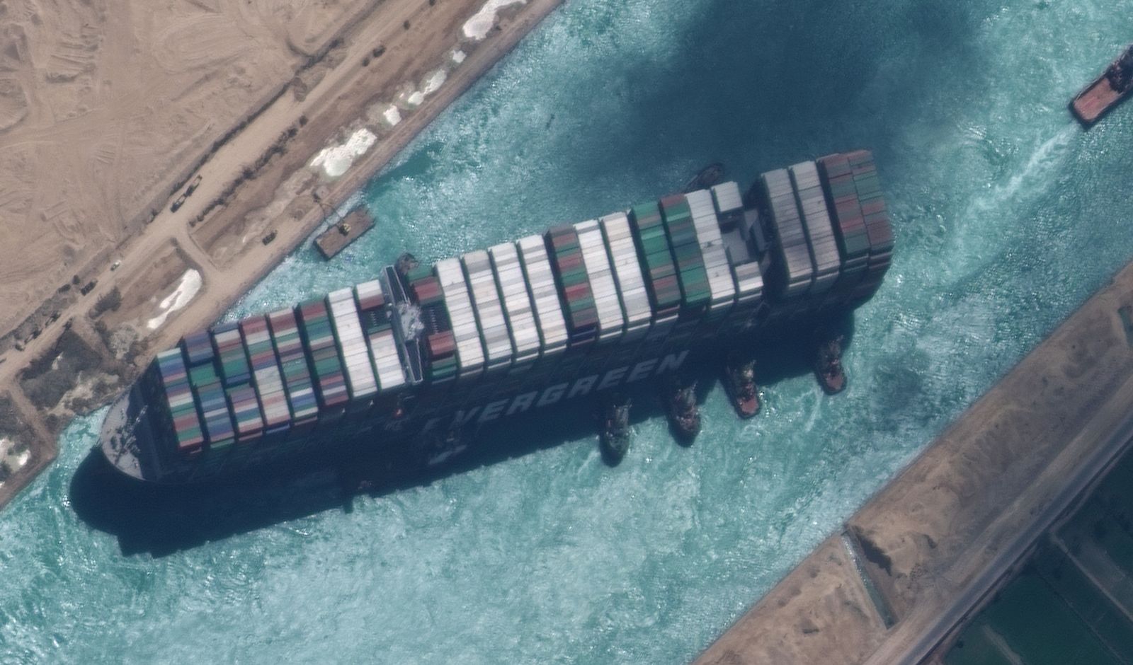 epa09105214 A handout satellite image made available by MAXAR Technologies shows , the Ever Given container ship after it has been moved away from the eastern bank of the canal and tugboats trying to reposition the ship, in the Suez Canal, Egypt, 29 March 2021. The head of the Suez Canal Authority announced on 29 March that the large container ship, which ran aground in the Suez Canal on 23 March, is now free floating after responding to the pulling maneuvers.  EPA/MAXAR TECHNOLOGIES HANDOUT MANDATORY CREDIT: SATELLITE IMAGE 2020 MAXAR TECHNOLOGIES -- the watermark may not be removed/cropped -- HANDOUT EDITORIAL USE ONLY/NO SALES HANDOUT EDITORIAL USE ONLY/NO SALES
