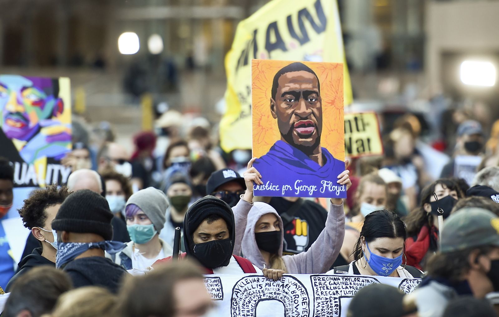 epa09105715 Protesters march through downtown Minneapolis on the first day of opening statements for the murder trial of former Minneapolis police officer Derek Chauvin who was charged in the death of George Floyd, in Minneapolis, Minnesota, USA, 29 March 2021.  EPA/CRAIG LASSIG