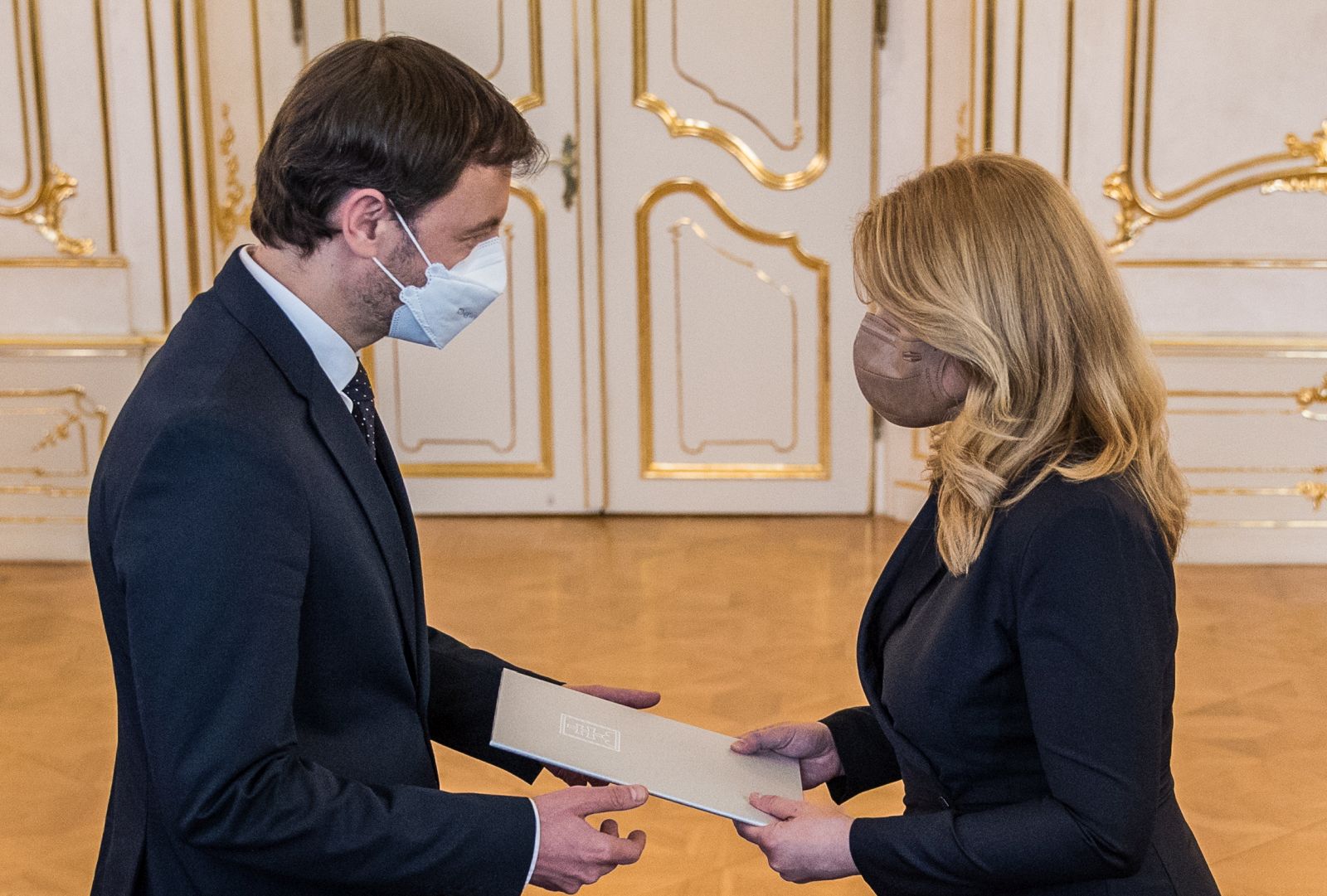 epa09106897 Slovak deputy prime minister Eduard Heger (L) receives a mandate to form new government from Slovak President Zuzana Caputova (R) in Bratislava, Slovakia, 30 March 2021. Slovak Prime Minister Matovic offered his resignation after his coalition partners did not agree with his COVID-19 pandemic management and his agreement to acquire 2 million doses of Russia's Sputnik V vaccine.  EPA/JAKUB GAVLAK