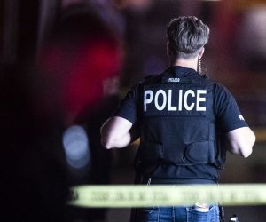 epa09109863 Police officers stand guard outside an office complex in the aftermath of a mass shooting in Orange, California, USA, 31 March 2021. At least four people were killed, including a child, while a fifth person was injured when a gunman opened fire at a business complex. The suspected shooter was reportedly transferred to a hospital after being taken into custody.  EPA/ETIENNE LAURENT