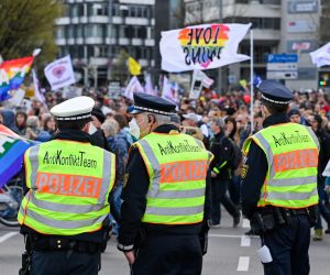 epa09113034 Police officers of the anti conflict team stand guard at the scene of a demonstration held by the ‘Querdenker' (lateral thinkers) movement against the German government's coronavirus restrictions in Stuttgart, Germany, 03 April 2021. Stuttgart is the center of the ‘Querdenker’ movement, founded by entrepreneur Michael Ballweg, as the broadest possible grouping against the government's COVID-19 measures. The police is deployed with several hundred units while thousands are protesting.  EPA/SASCHA STEINBACH