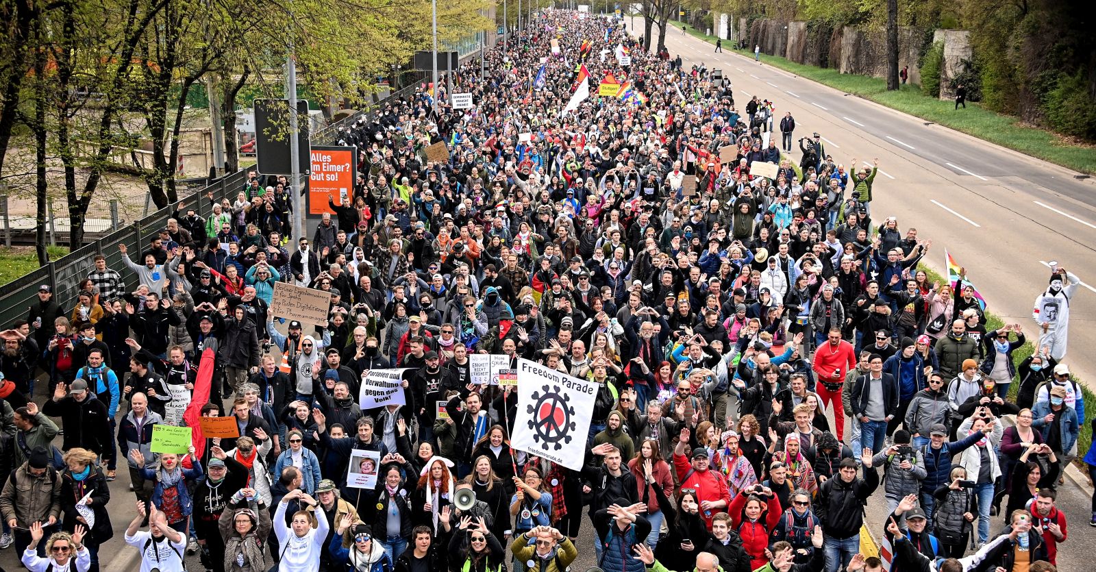 epa09113624 Protesters hold banners during a demonstration held by the ‘Querdenker' (lateral thinkers) movement against the German government's coronavirus restrictions in Stuttgart, Germany, 03 April 2021. Stuttgart is the center of the ‘Querdenker’ movement, founded by entrepreneur Michael Ballweg, as the broadest possible grouping against the government's COVID-19 measures. The police is deployed with several hundred units while thousands are protesting.  EPA/SASCHA STEINBACH
