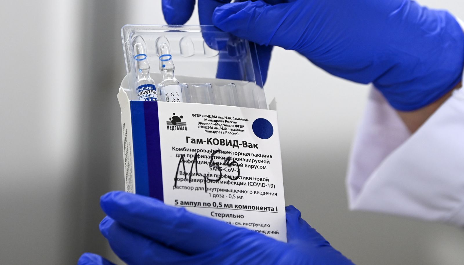epa09116996 A nurse takes out vials of the Russian Sputnik V vaccine against coronavirus during vaccination at the Arena 'Boris Trajkovski' in Skopje, Republic of North Macedonia, 05 April 2021. After new donation of 40,000 doses of the Sputnik V from Serbia, North Macedonia start its coronavirus disease (COVID-19) vaccination campaign of police officers, army and journalists with Russian Sputnik V vaccine.  EPA/GEORGI LICOVSKI