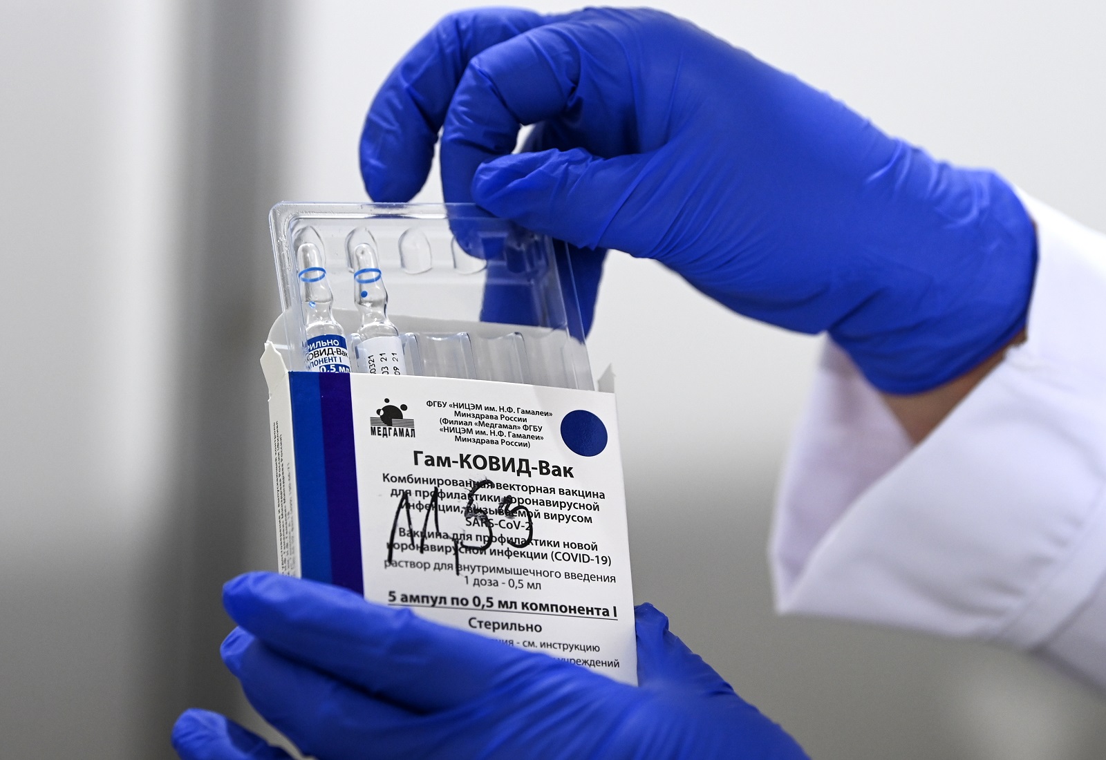 epa09120594 A nurse takes out vials of the Russian Sputnik V vaccine against Covid-19 during vaccination at the Arena 'Boris Trajkovski' in Skopje, North Macedonia, 05 April 2021 (reissued 07 April 2021). The prime minister of the German federal state Bavaria Soeder on 07 April 2021 said the state had signed a preliminary contract over a purchase of Russian COVID-19 vaccine Sputnik V. An approval for the vaccine by the European Medicines Agency (EMA) is pending.  EPA/GEORGI LICOVSKI *** Local Caption *** 56807518