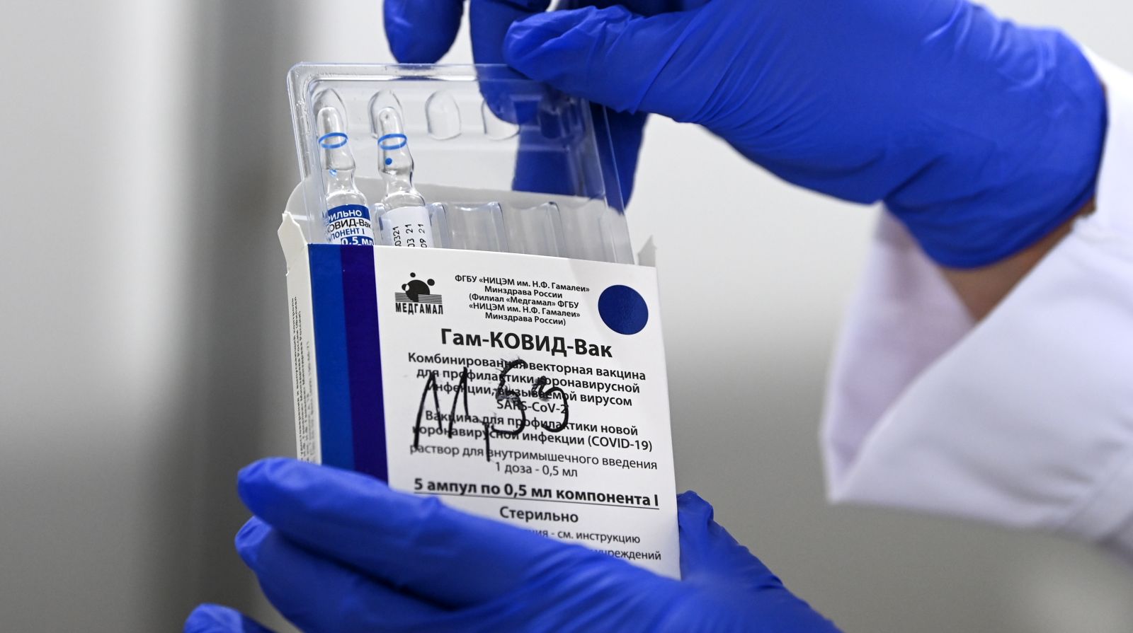 epa09120594 A nurse takes out vials of the Russian Sputnik V vaccine against Covid-19 during vaccination at the Arena 'Boris Trajkovski' in Skopje, North Macedonia, 05 April 2021 (reissued 07 April 2021). The prime minister of the German federal state Bavaria Soeder on 07 April 2021 said the state had signed a preliminary contract over a purchase of Russian COVID-19 vaccine Sputnik V. An approval for the vaccine by the European Medicines Agency (EMA) is pending.  EPA/GEORGI LICOVSKI *** Local Caption *** 56807518