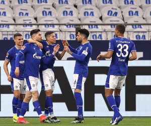 epa09128753 Suat Serdar (2-L) of FC Schalke 04 celebrates with team-mates after scoring their side's first goal during the German Bundesliga soccer match between FC Schalke 04 and FC Augsburg at Veltins-Arena in Gelsenkirchen, Germany, 11 April 2021.  EPA/Lars Baron / POOL CONDITIONS - ATTENTION:  The DFL regulations prohibit any use of photographs as image sequences and/or quasi-video.