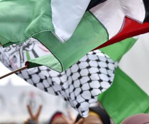 epa09130430 Palestinian refugees carry national flags as they shout slogans during a protest outside of the Palestine Embassy in Beirut, Lebanon, 12 April 2021. Hundreds of Palestinian refugees in Lebanon gathered outside of the Palestine Embassy during a protest to demand to find a solution for the Palestinian refugees fleeing from the war in Syria to Lebanon and to secure international protection for them. Over 470,000 refugees are registered with UNRWA in Lebanon. About 45 percent of them live in the country’s 12 refugee camps.  EPA/WAEL HAMZEH
