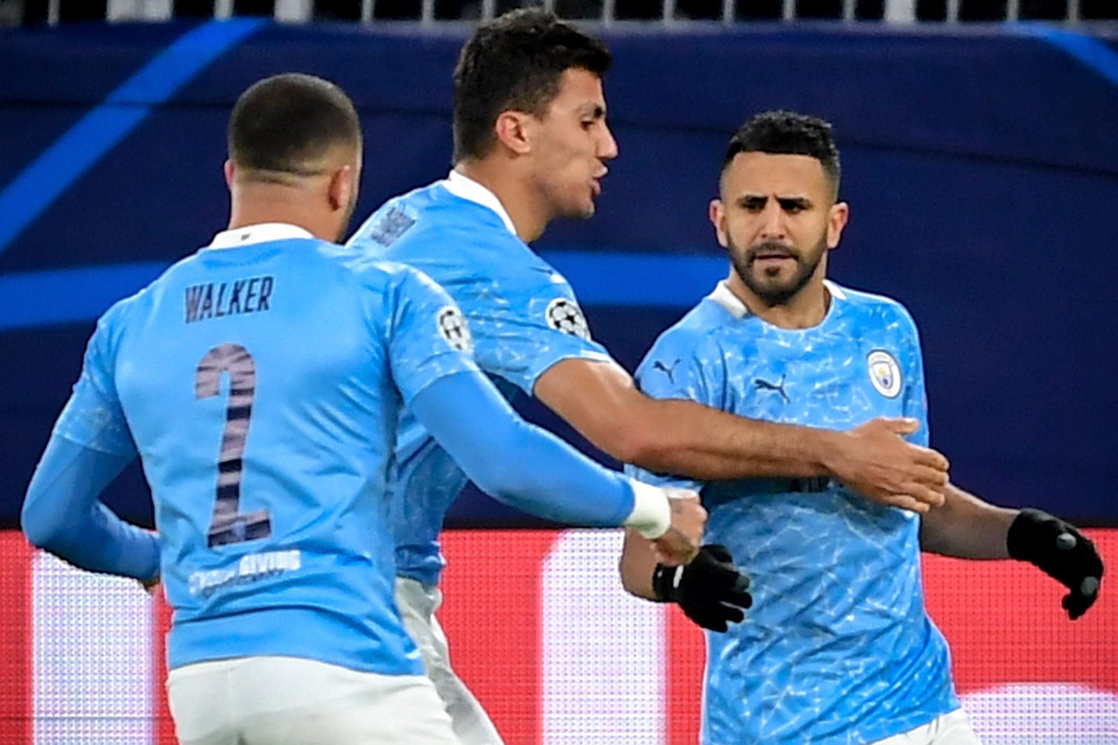 epa09135845 Manchester City's Riyad Mahrez celebrates with his teammates after scoring the 1-1 equalizer from the penalty spot during the UEFA Champions League quarter final, second leg soccer match between Borussia Dortmund and Manchester City in Dortmund, Germany, 14 April 2021.  EPA/FREDERIC SCHEIDEMANN / POOL