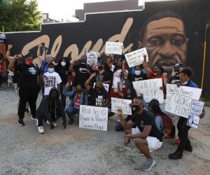 epa09148463 People react near a mural of George Floyd after former Minneapolis Police Department Police Officer Derek Chauvin was found guilty on all counts in Minneapolis, Minnesota  in the death of Floyd in Atlanta, Georgia USA, 20 April 2021. Chauvin was found guilty on charges of second-degree murder, third-degree murder and second-degree manslaughter.  EPA/ERIK S. LESSER