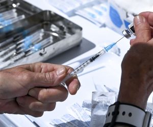 epa09154595 A medical staff prepares dose of Pfizer-BioNTech COVID-19 vaccine during the vaccination at the Arena 'Boris Trajkoovski' in Skopje, Republic of North Macedonia, 23 April 2021. Members of Macedonian Parliament received first dose of Russian Sputnik V vaccine on 23 April as the country continues its coronavirus disease (COVID-19) vaccination campaign with elderly people and critical groups for the state infrastructure.  EPA/GEORGI LICOVSKI