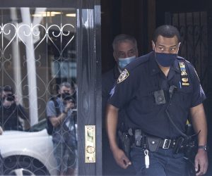 epa09165815 A New York City police officer exits the building where Rudy Giuliani, a former lawyer for President Donald Trump, has an apartment in New York, New York, USA, 28 April 2021. United States federal authorities reportedly raided the apartment at this location as part of an ongoing criminal investigation into Giuliani's dealings with Ukraine.  EPA/JUSTIN LANE
