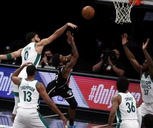 epa09156026 Boston Celtics forward Jayson Tatum (L) fouls Brooklyn Nets guard Kyrie Irving (C) as he tries to put up a shot in the first half of the NBA basketball game between the Boston Celtics and the Brooklyn Nets at the Barclays Center in Brooklyn, New York, USA, 23 April 2021.  EPA/JASON SZENES SHUTTERSTOCK OUT