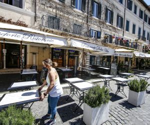 epa09156579 A worker sets up tables in a restaurant in Piazza Navona in downtown of Rome, Italy, 24 April 2021. Most of Italy is set to see a significant easing of its COVID-19 restrictions when the reintroduction of moderate-risk yellow zones into the nation's tiered system of coronavirus-prevention measures kicks in on 26 April. At the moment regions are only classed as high-risk red zones or medium-high-risk orange zones. But 13 regions and two autonomous provinces are set to become yellow zones where, among other things, restaurants will be able to serve people at outdoor tables, rather than being limited to takeaways and home deliveries, next week.  EPA/FABIO FRUSTACI