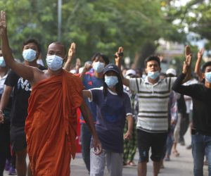 epa09168888 A Myanmar Buddhist monk and demonstrators flash three-finger salutes as they marching during an anti-military coup protest in Mandalay, Myanmar, 30 April 2021. The nine leaders of Southeast Asian (ASEAN) countries are calling the military junta leader to restore democracy and immediately stop the violence crackdown on demonstrators that held street protests against the military coup in Myanmar.  EPA/STRINGER