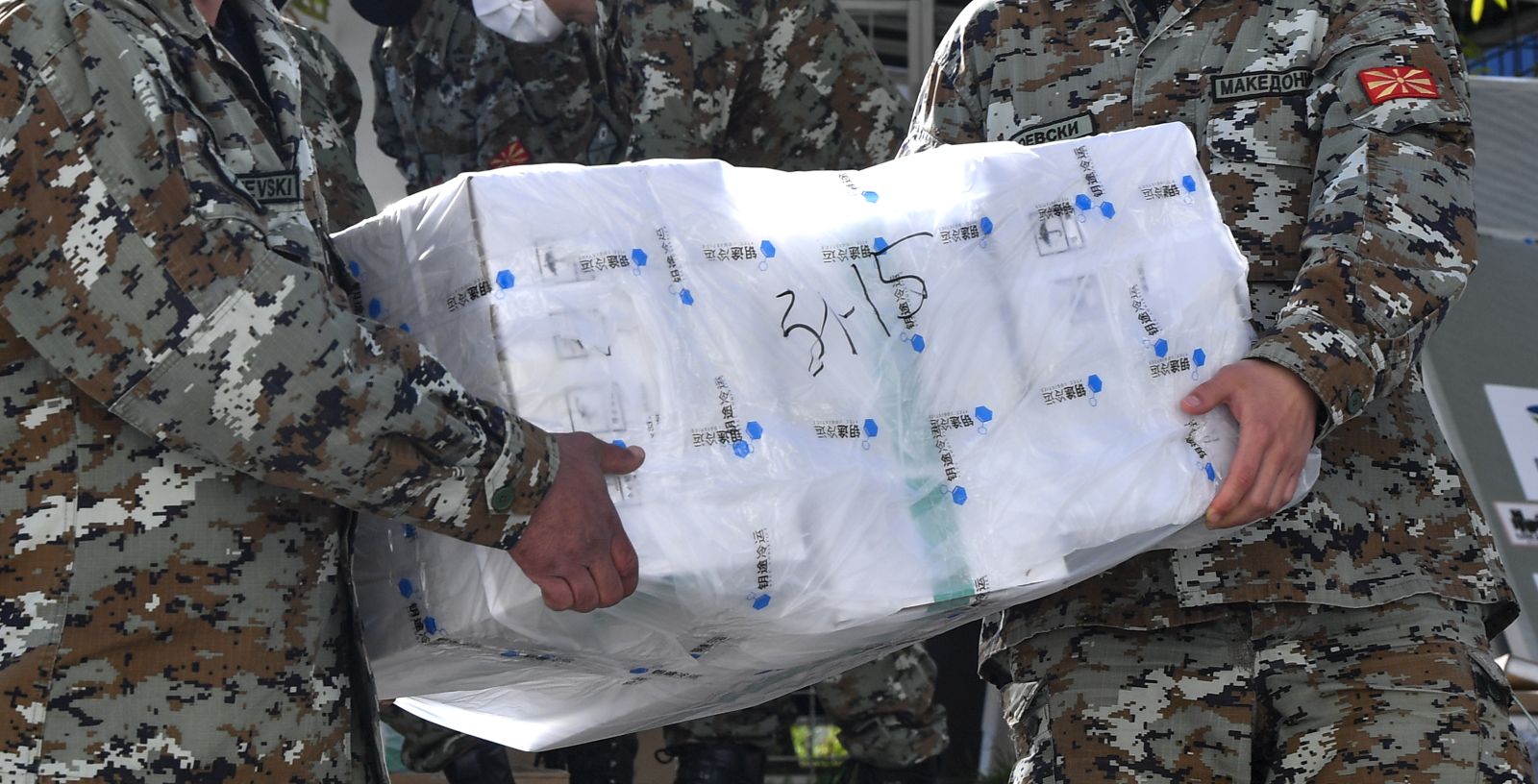epa09169077 Macedonian soldiers carry the boxes of Chinese Sinopharm COVID-19 vaccines in a cold room at Jane Sandanski Clinic in Skopje, Republic of North Macedonia, 30 April 2021. This is the first large shipment of vaccine to arrive in North Macedonia since the beginning of the pandemic. The North Macedonia's authorities expect the beginning of mass vaccination after the Easter holidays in the country.  EPA/GEORGI LICOVSKI