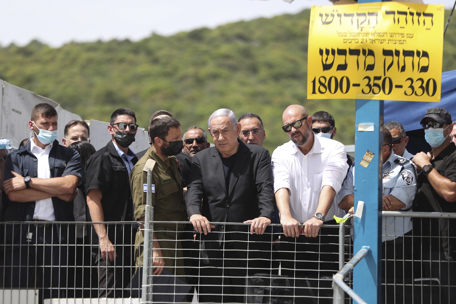 epa09169055 Israeli Prime Minister Benjamin Netanyahu (C) visits Mount Meron, northern Israel, where fatalities were reported among the thousands of ultra-Orthodox Jews gathered at the tomb of a 2nd-century sage for annual commemorations that include all-night prayer and dance, in Mount Meron, Israel, 30 April 2021. Dozens of people were killed and injured in the revelry complex on Mount Meron, after an apparent stampede occured during an event marking the end of the Jewish holiday of Lag Ba'Omer, the day marks the anniversary of the death of Rabbi Shimon bar Yochai, a sage from some 1,800 years ago, and the day on which he revealed the secrets of the 'kabbalah,' or Jewish mysticism.  EPA/RONEN ZVULUN / POOL
