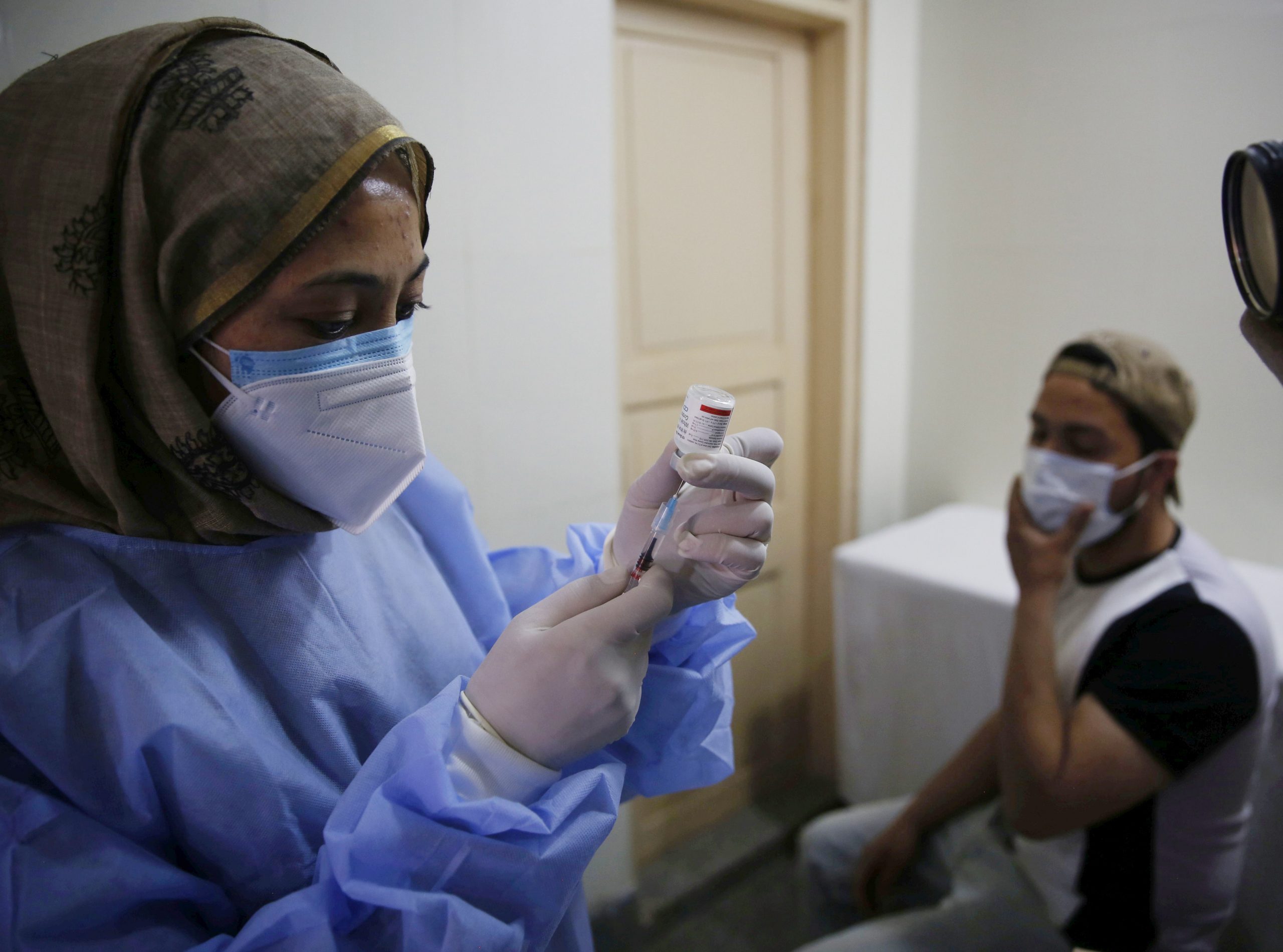 epa09171274 A medic administers the first dose of COVAXIN vaccine to youngsters at SMHS Hospital in Srinagar, the summer capital of Indian Kashmir, 01 May 2021. Government kick starts the inoculation drive to cover the 18-45 age groups. The authorities have already imposed an 84-hour lockdown from 7 pm Thursday in  20 districts of Indian Kashmir including Srinagar in view of consistent surge in Covid-19 cases. The lockdown would be lifted at 7 am on Monday (May 3).  EPA/FAROOQ KHAN