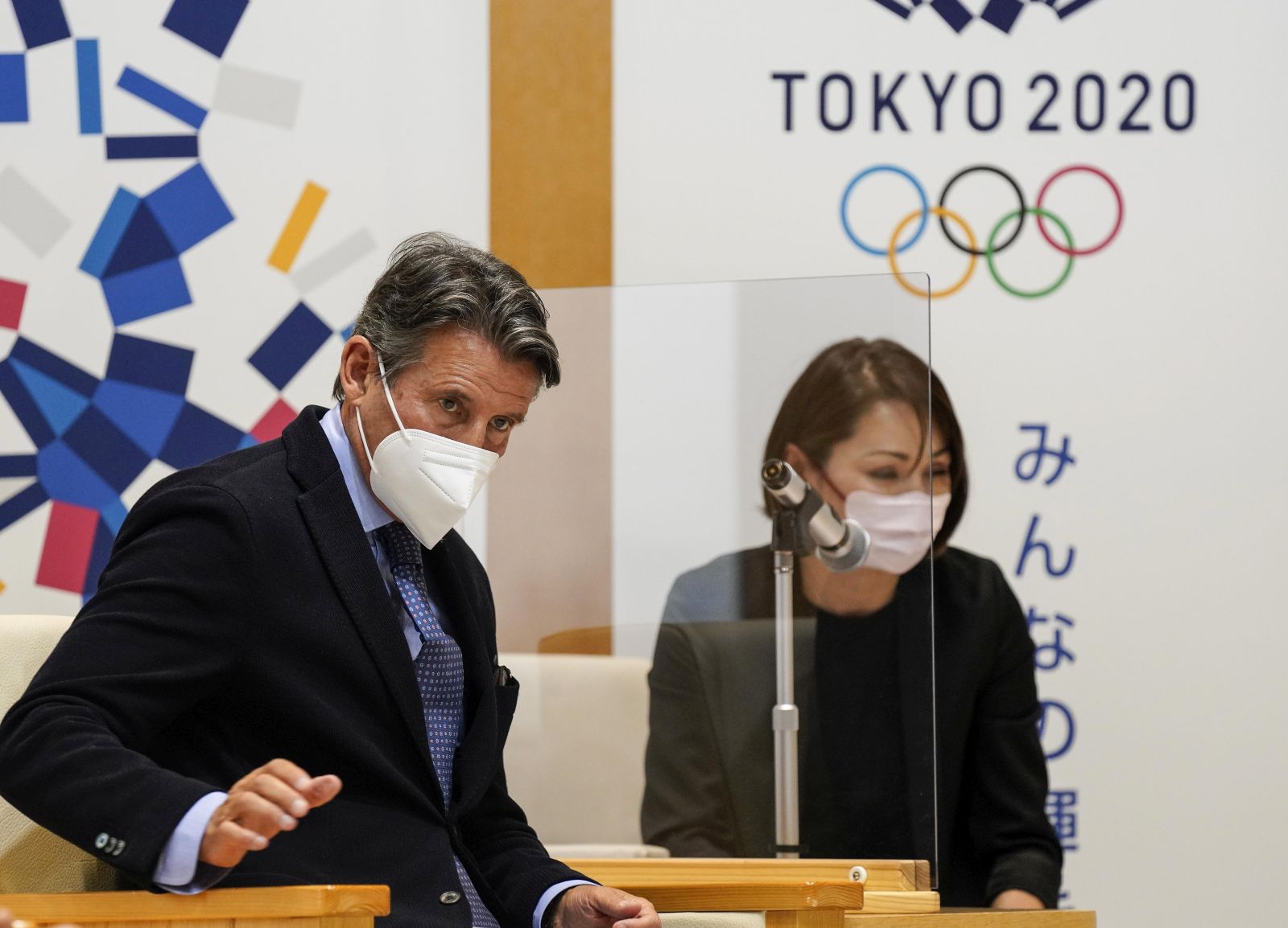 epa09182226 Sebastian Coe (L), World Athletics President, listens to Tokyo Governor Yuriko Koike during their meeting at the Tokyo Metropolitan Government office in Tokyo, Japan, 07 May 2021.  EPA/KIMIMASA MAYAMA