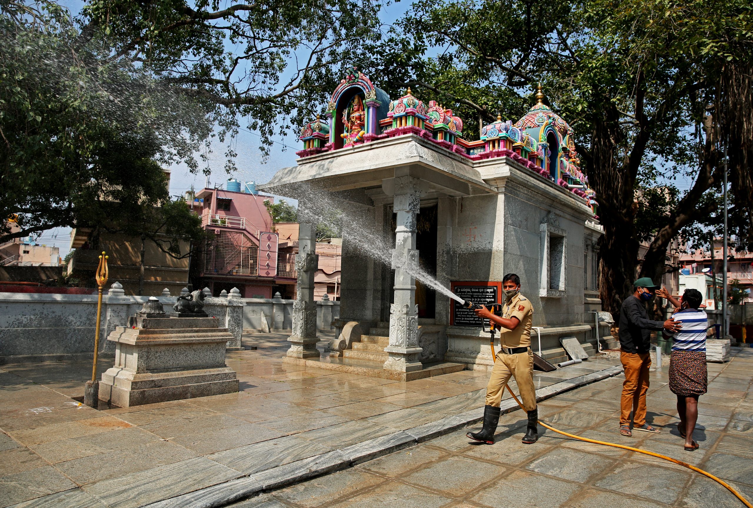 epa09182336 Fire force personnel and workers of the local Bruhat Bengaluru Mahanagara Palike (BBMP) administrative body for civic and infrastructural assets of the Greater Bangalore metropolitan area spray disinfectant during an extended lockdown due to the outbreak of COVID-19 disease in Bangalore, India, 07 May 2021. Karnataka state recorded 49,058 new COVID-19 cases, while Bangalore recorded 23,706 cases, the highest daily cases in May 2021. India has recorded 414,188 fresh COVID-19 cases and 3,915 deaths in the last 24 hours.  EPA/JAGADEESH NV