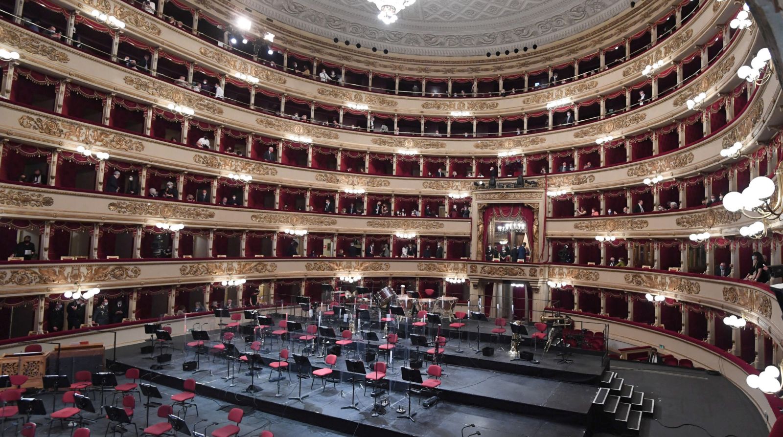 epa09189929 People wearing face masks in the Teatro alla Scala to attend a concert in Milan, Italy, 10 May 2021. The concert directed by the musical director Riccardo Chailly that commemorates the 75th anniversary of the reopening of the Piermarini Hall after the years of the dictatorship, the World War II and the bombing with the historic concert directed by Arturo Toscanini on 11 May 1946. The concert is the first event with the presence of audience since 19 October 2020. Only 500 tickets of the approximately 2,000 seats were made available as required by current anti-Covid legislation.  EPA/Daniel Dal Zennaro